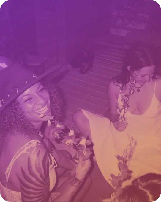 Two people laughing together at a gathering