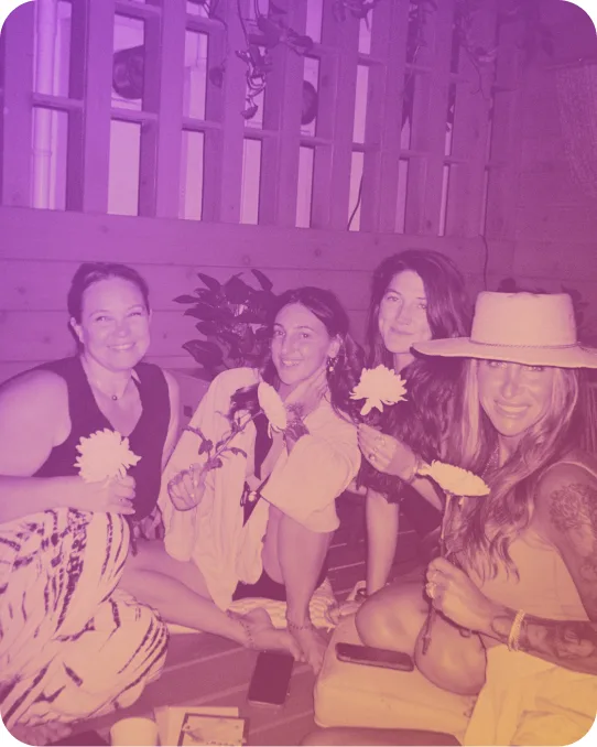 A group seated together holding flowers