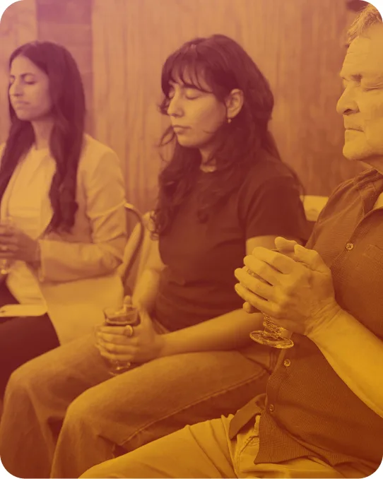 Three people sitting close in quiet conversation