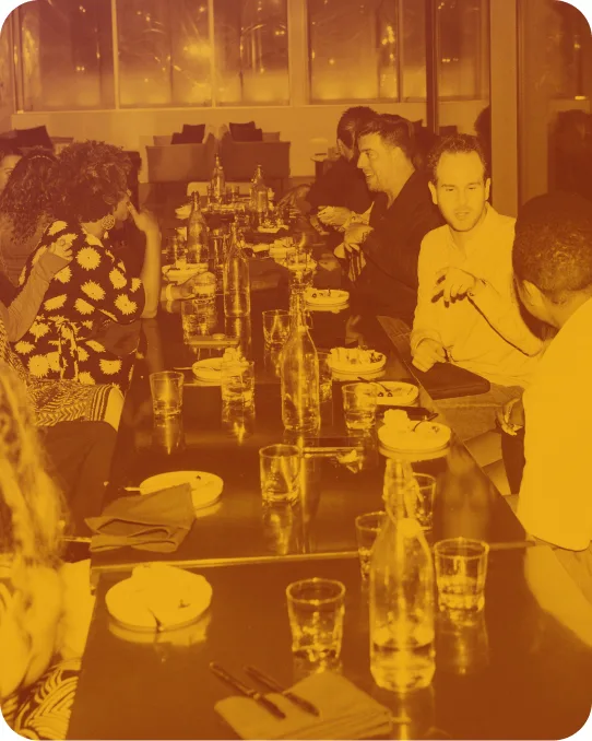 A long table of people sharing a meal