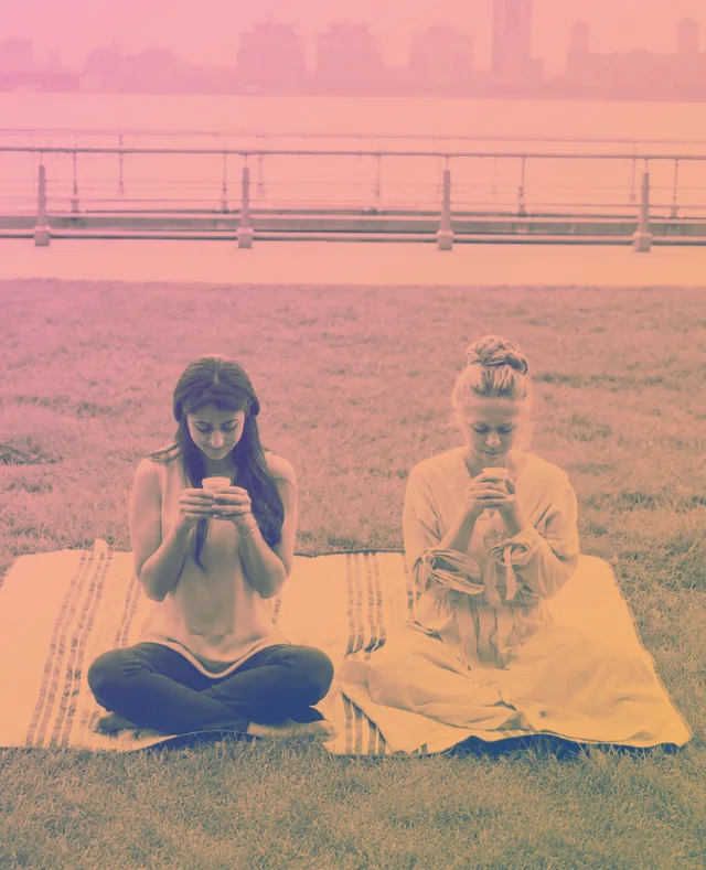 Two people meditating outdoors